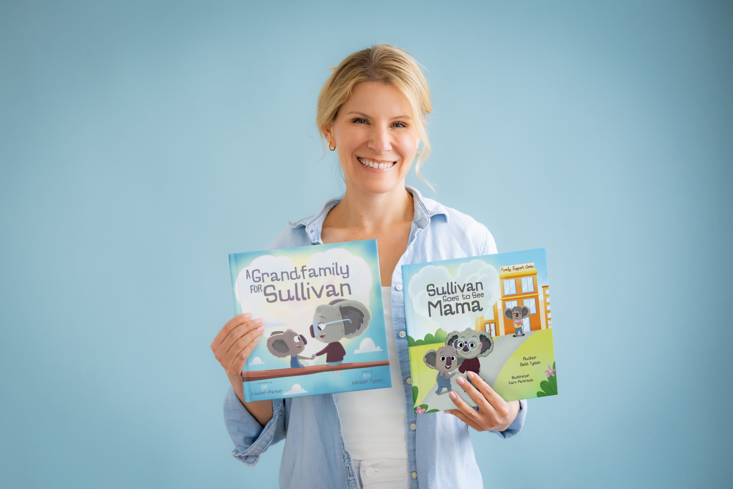 Photo of Beth Tyson holding her books A Grandfamily for Sullivan and Sullivan Goes to See Mama. Available on Amazon.