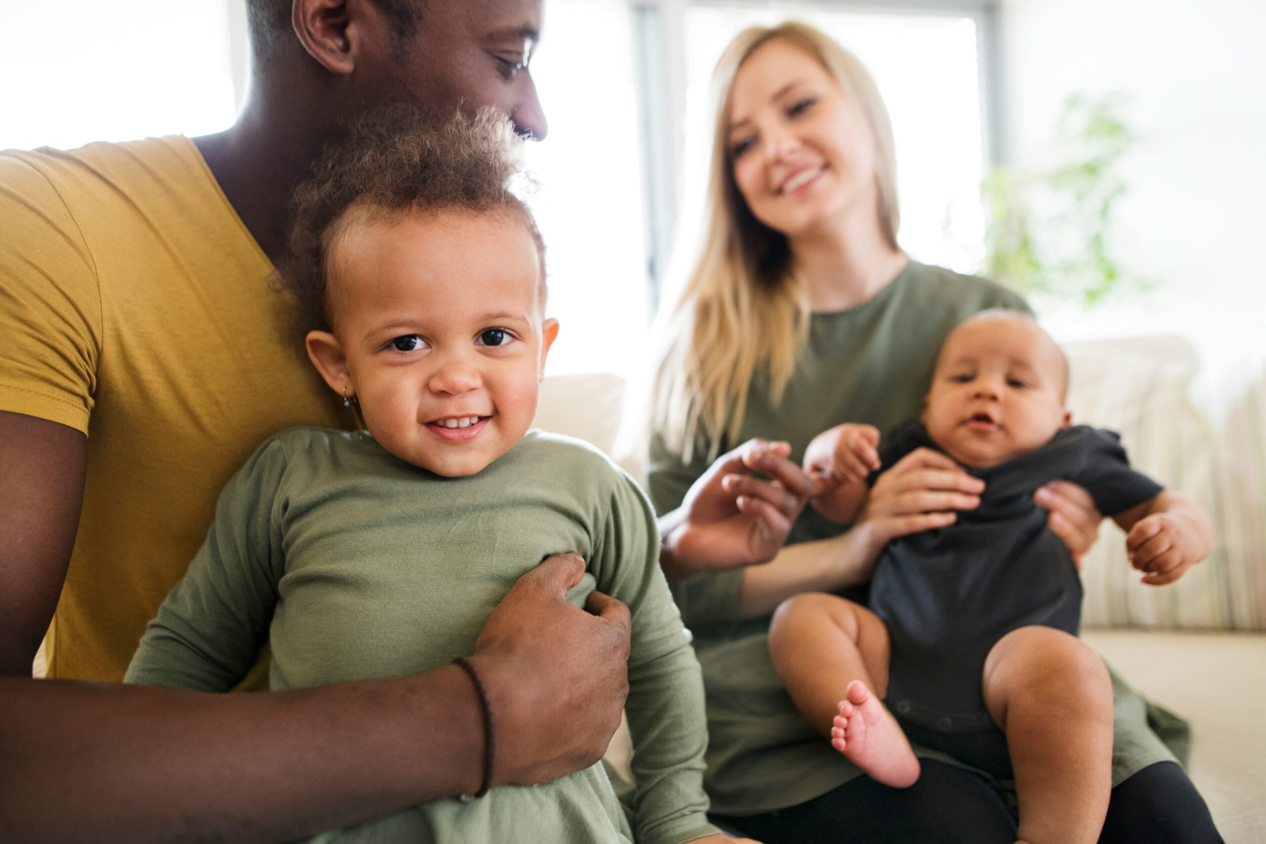 photo of a mother and father holding their young children
